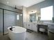 Elegant bathroom with double vanity and soaking tub at 16820 Bolsena Dr, Bella Collina, FL 34756