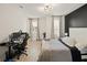 Modern bedroom with a workspace and a bed, offering functionality and style at 16820 Bolsena Dr, Bella Collina, FL 34756