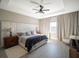 Bright bedroom with king-size bed and ceiling fan at 16820 Bolsena Dr, Bella Collina, FL 34756