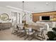 Spacious dining area features a long wooden table with modern chairs at 16820 Bolsena Dr, Bella Collina, FL 34756