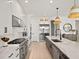 Open concept kitchen with stainless steel appliances and marble countertops at 16820 Bolsena Dr, Bella Collina, FL 34756