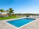 Relaxing pool with lake view and lush landscaping at 16820 Bolsena Dr, Bella Collina, FL 34756