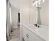 Modern bathroom with a white vanity, quartz countertop, and black fixtures at 16820 Bolsena Dr, Bella Collina, FL 34756