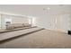 Spacious home theater with tiered seating and neutral carpeting at 16820 Bolsena Dr, Bella Collina, FL 34756