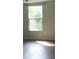 Bright bedroom featuring a window and wood flooring at 214 W Dade Ave, Bushnell, FL 33513