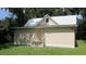 Small house with a metal roof and simple exterior design at 214 W Dade Ave, Bushnell, FL 33513