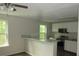 Renovated kitchen featuring stainless steel appliances and a breakfast bar at 214 W Dade Ave, Bushnell, FL 33513