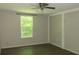 Spacious bedroom with large window and ceiling fan at 214 W Dade Ave, Bushnell, FL 33513