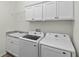 Laundry room with washer, dryer, and upper cabinets at 2740 Alder Ave, Middleton, FL 34762