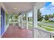 Spacious front porch with white columns and wooden flooring at 1162 Fiesta Key Cir, Lady Lake, FL 32159