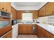 Kitchen with wood cabinets, a built-in oven, and a microwave at 5011 Griffin View Dr, Lady Lake, FL 32159
