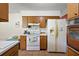 Kitchen with wood cabinets, a stove, and a refrigerator at 5011 Griffin View Dr, Lady Lake, FL 32159