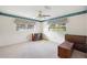 Well-lit bedroom featuring neutral carpeting and two large windows at 5011 Griffin View Dr, Lady Lake, FL 32159
