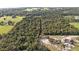 Aerial view of property with wooded area and nearby houses at 5011 Griffin View Dr, Lady Lake, FL 32159