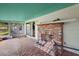 Relaxing screened porch with brick fireplace, tile floor, and view of backyard at 5011 Griffin View Dr, Lady Lake, FL 32159