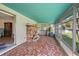 Enclosed porch with tiled floor, brick fireplace and view of the backyard at 5011 Griffin View Dr, Lady Lake, FL 32159