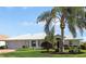 Single-story home with a palm tree and well-maintained lawn at 4809 Saint Andrews Arc, Leesburg, FL 34748