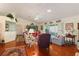 Spacious living room with hardwood floors and access to a screened porch at 4809 Saint Andrews Arc, Leesburg, FL 34748