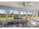 Relaxing sunroom with tiled floor and views of the backyard at 4809 Saint Andrews Arc, Leesburg, FL 34748