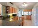 Kitchen with light wood cabinets, granite countertops, and ample counter space at 4809 Saint Andrews Arc, Leesburg, FL 34748
