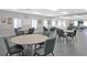 Community meeting room with tables and chairs at 4809 Saint Andrews Arc, Leesburg, FL 34748