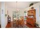 Bright dining room with hardwood floors and wood hutch at 4809 Saint Andrews Arc, Leesburg, FL 34748