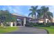 Two-story house with porte-cochere and palm trees at 4809 Saint Andrews Arc, Leesburg, FL 34748