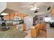 Well-equipped kitchen with light wood cabinets, granite countertops, and island at 4809 Saint Andrews Arc, Leesburg, FL 34748