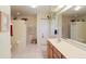 Bathroom with double vanity, separate shower, and linen closet at 4809 Saint Andrews Arc, Leesburg, FL 34748