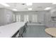Community craft room with long tables and cabinets at 4809 Saint Andrews Arc, Leesburg, FL 34748