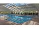 Indoor pool with skylights and seating area at 4809 Saint Andrews Arc, Leesburg, FL 34748
