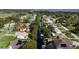 Aerial view of canal-front home in a residential neighborhood at 12442 Blue Heron Way, Leesburg, FL 34788