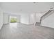 Spacious living room with gray tile floors and sliding glass doors at 1180 Dora Parc Ln, Mount Dora, FL 32757