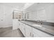 Elegant bathroom with double vanity, large mirror, and a walk-in shower at 1180 Dora Parc Ln, Mount Dora, FL 32757