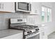 Modern kitchen features with stainless steel range and microwave at 1180 Dora Parc Ln, Mount Dora, FL 32757