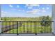 Scenic balcony view overlooking a tranquil lake and boardwalk at 1180 Dora Parc Ln, Mount Dora, FL 32757