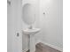 Convenient powder room with pedestal sink and round mirror at 1180 Dora Parc Ln, Mount Dora, FL 32757