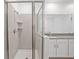 Modern bathroom with a large walk-in shower and gray tile at 1180 Dora Parc Ln, Mount Dora, FL 32757