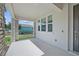 Covered front porch with stone accents and modern door at 1180 Dora Parc Ln, Mount Dora, FL 32757