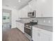 Modern kitchen with stainless steel appliances and white cabinets at 1180 Dora Parc Ln, Mount Dora, FL 32757