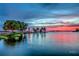 Scenic waterfront view with a lighthouse at sunset at 1180 Dora Parc Ln, Mount Dora, FL 32757
