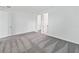 Spacious bedroom with grey carpet and access to a bathroom at 1180 Dora Parc Ln, Mount Dora, FL 32757