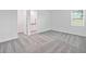 Bright bedroom with carpet flooring and en-suite bathroom access at 1180 Dora Parc Ln, Mount Dora, FL 32757