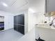 Laundry room with washer, dryer, storage cabinets, and a sink at 1559 Lakeshore Dr, Eustis, FL 32726