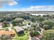 Aerial view showing home's location, landscape, and proximity to a lake at 1559 Lakeshore Dr, Eustis, FL 32726
