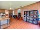 Sunroom with brick walls, tiled floors, and comfortable seating area at 1559 Lakeshore Dr, Eustis, FL 32726