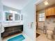 Modern bathroom with double vanity, tiled floors, and updated fixtures at 1559 Lakeshore Dr, Eustis, FL 32726