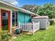 Teal home with a white fence, AC unit and storage shed in backyard at 1559 Lakeshore Dr, Eustis, FL 32726