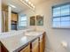 Bathroom with single sink vanity, wood cabinets, and a large mirror at 1559 Lakeshore Dr, Eustis, FL 32726