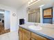 Clean bathroom with a vanity, shower, and wood cabinets at 1559 Lakeshore Dr, Eustis, FL 32726